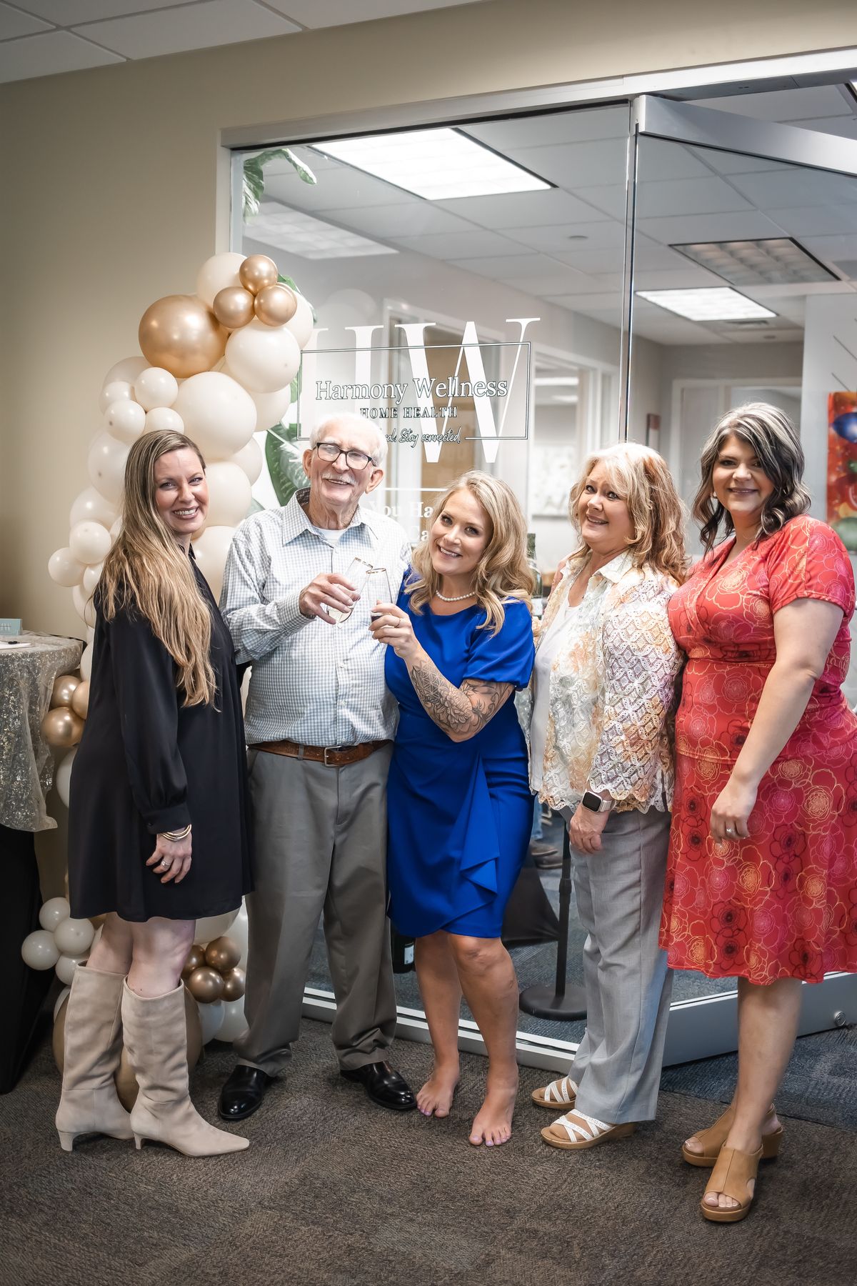 Group photo by the Harmony Wellness sign