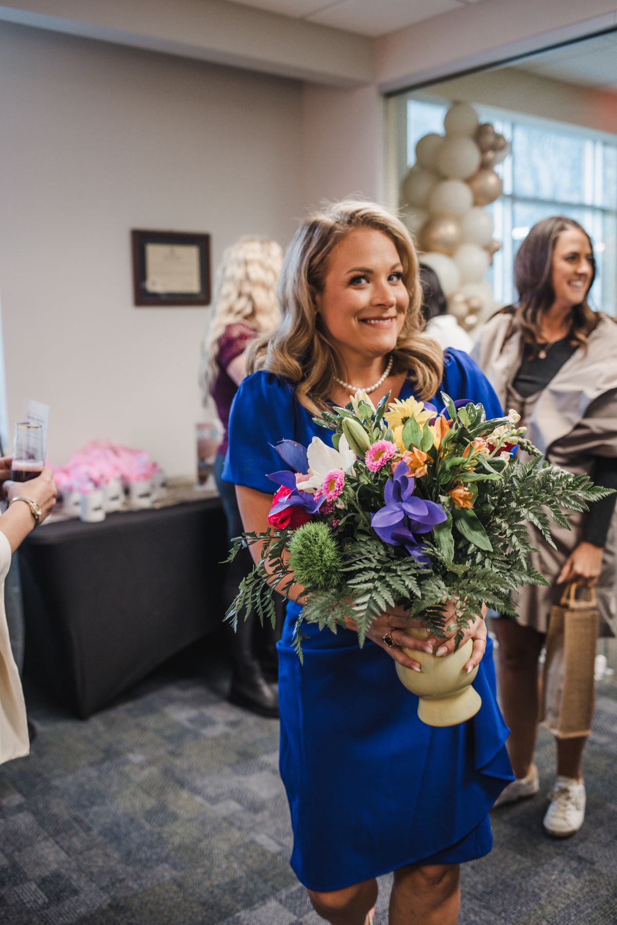 Sarah Foust receiving flowers at Grand Opening